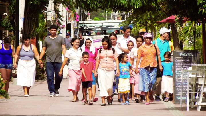 Latino families walking along a street